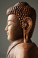 Closeup of wooden Buddha. - Nugene Chiang