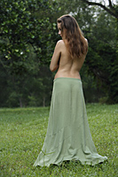 Back view of topless woman standing outside. - Nugene Chiang