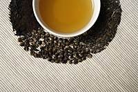 Crop shot of Green tea and leaves. - Nugene Chiang