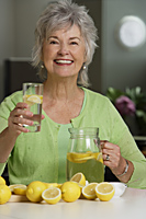 Mature woman drinking lemon aid. - Nugene Chiang