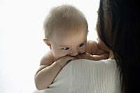 mother holding baby looking over her shoulder - Alex Mares-Manton
