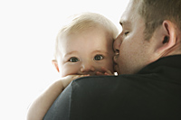 father holding baby and kissing his cheek - Alex Mares-Manton