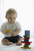 baby playing with toy blocks - Alex Mares-Manton