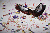 close up of red shoes with confetti on floor - Nugene Chiang