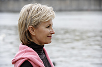 profile of mature woman looking at river - Alex Hajdu
