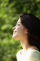 profile of young woman smiling with eyes closed - Alex Mares-Manton