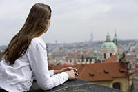 young woman looking at view of Prague - Alex Hajdu