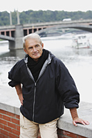 mature man standing near bridge and smiling - Alex Hajdu