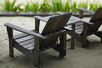 wooden chairs on sand - Alex Mares-Manton