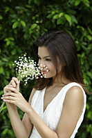 young woman smelling flowers - Alex Mares-Manton