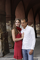 young couple hugging in front of old building - Alex Hajdu