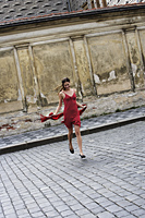 young woman running across street in red dress - Alex Hajdu