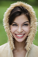 head shot of smiling young woman wearing fur hood. - Alex Mares-Manton