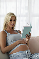 Pregnant woman reading a book - Alex Mares-Manton