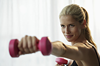 Head shot of blond woman working out with weights - Alex Mares-Manton