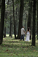 woman and man holding hands in forrest - Alex Mares-Manton