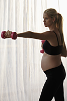 pregnant woman working out with weights - Alex Mares-Manton