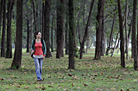 young woman walking through trees - Alex Mares-Manton
