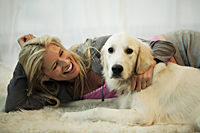 blond woman playing with her dog - Alex Mares-Manton